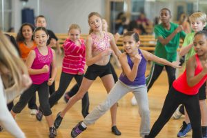 Diverse group of children taking a dance fitness class